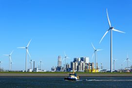 Flussansicht mit Windrädern und Kraftwerk